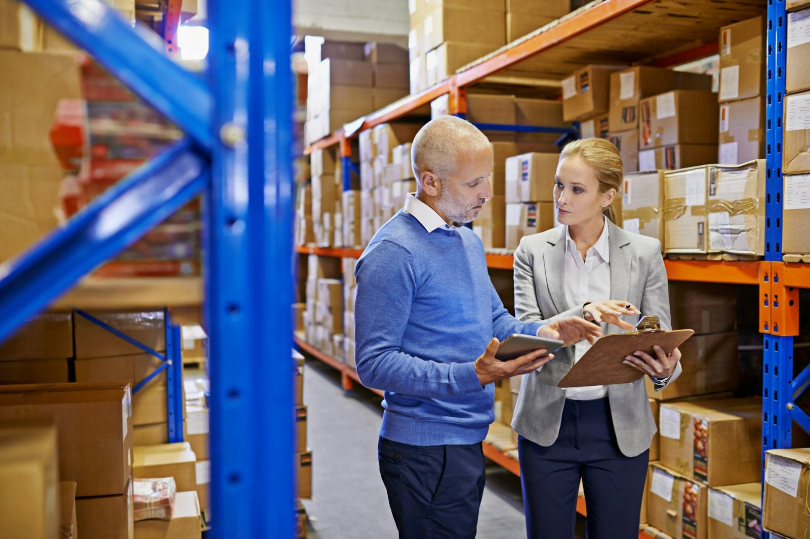 Shot of a man and woman inspecting inventory in a large distribution warehouse